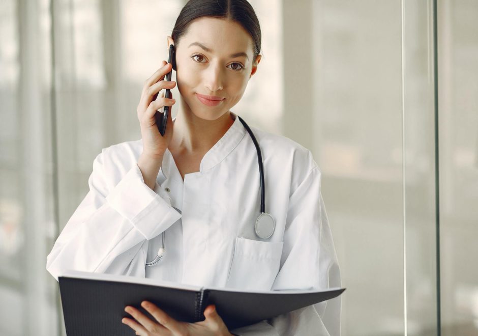 Medical staff holding the cellphone into the ear